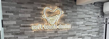 The image shows a sign with an emblem and text on a brick wall inside a room, likely indicating a brand or establishment.